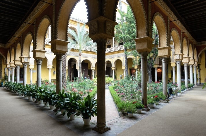 View of the open balcony and the garden at Palacio de las Duenas.