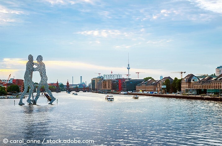 A boat on a tour of Berlin passing by the Molecule Men.