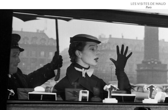 A black-and-white photo of a woman’s reflection in the window of a prestigious jewelry house at the Place Vendôme in Paris.